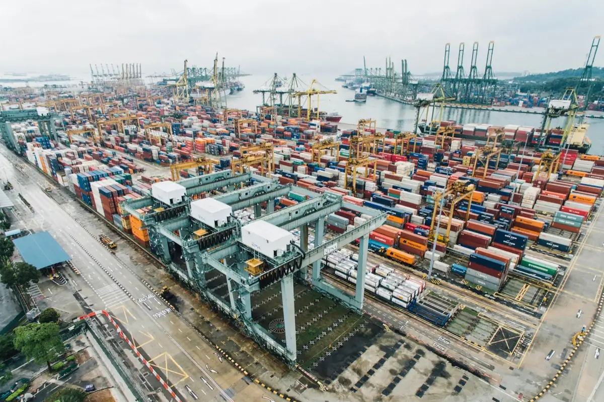 Aerial view of a container terminal with gantry cranes and stacked containers at a major port